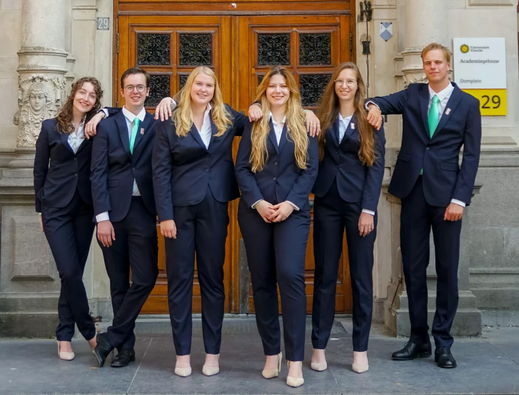 Six young Amino members in formal suits posing