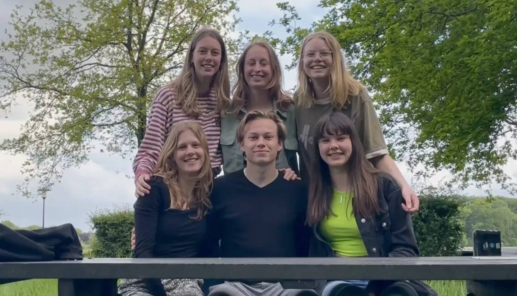 Six young Amino members laughing together